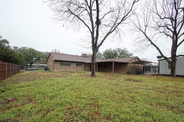 rear view of property with a yard