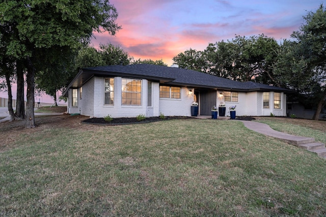 view of front of property with a lawn