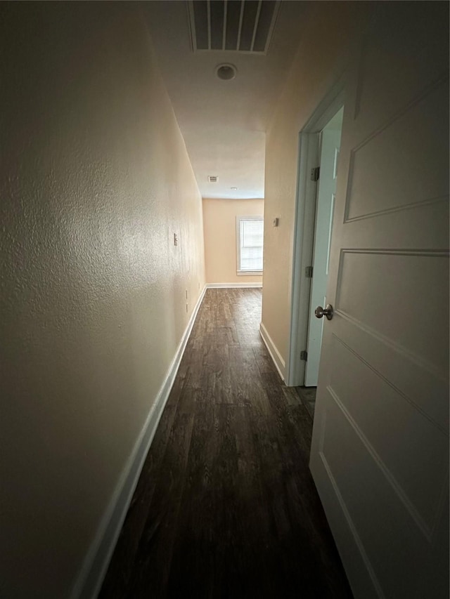 corridor with dark hardwood / wood-style floors