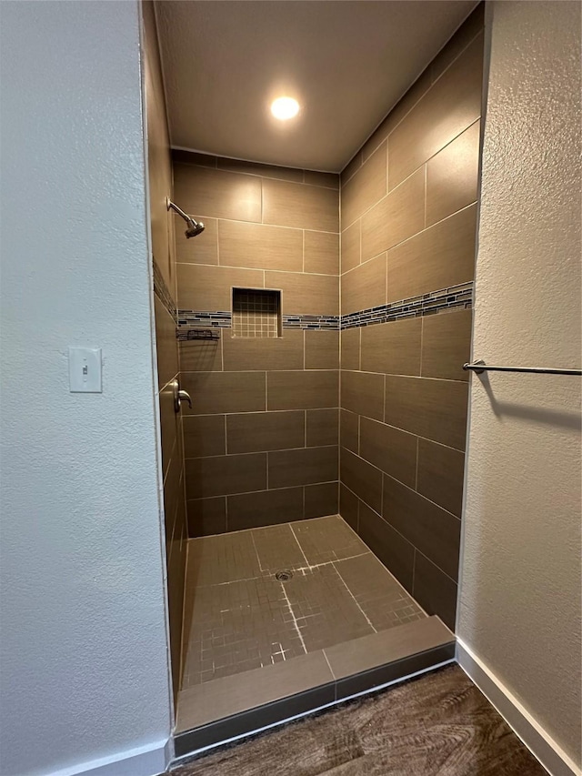 bathroom with tiled shower