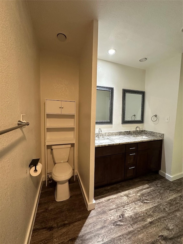 bathroom featuring vanity, toilet, and hardwood / wood-style floors