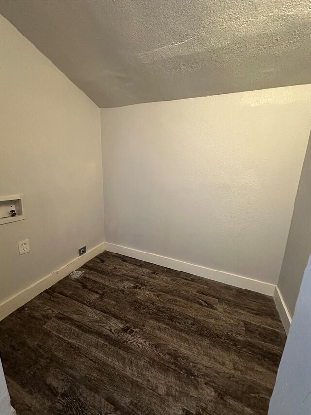 empty room featuring dark wood-type flooring and a chandelier