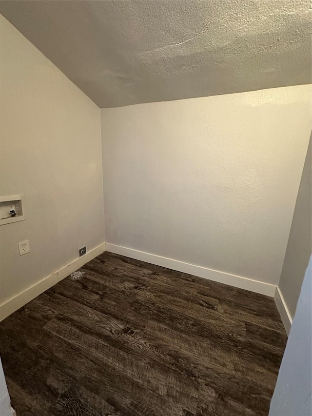 unfurnished room with a textured ceiling and dark hardwood / wood-style flooring