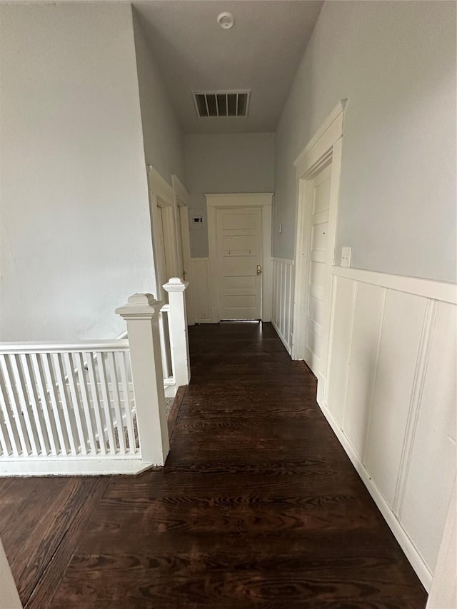 hallway with dark hardwood / wood-style floors