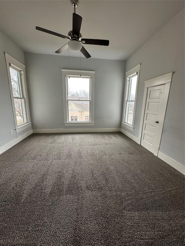 carpeted empty room featuring ceiling fan