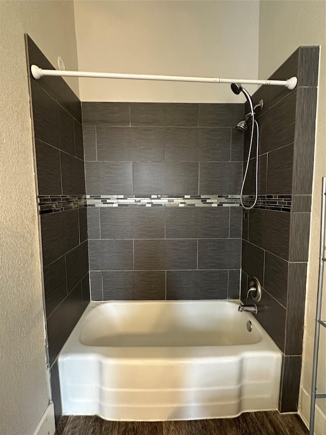 bathroom featuring hardwood / wood-style floors and tiled shower / bath