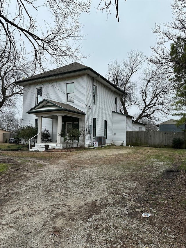 back of house with a porch and cooling unit