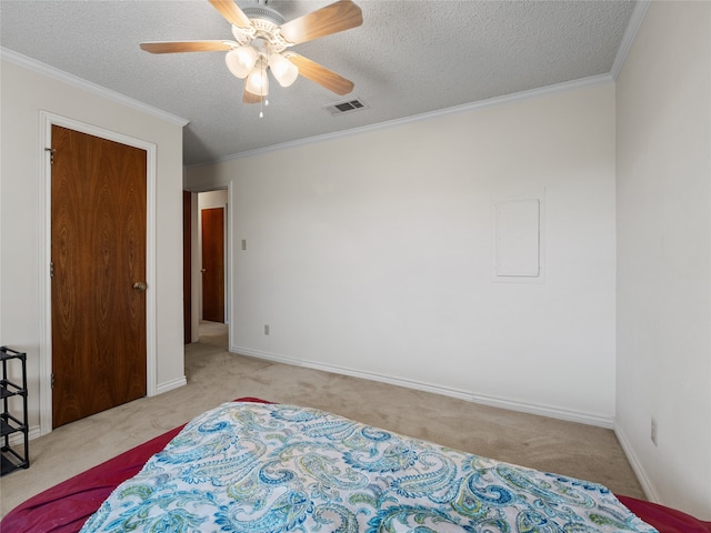 bedroom with a textured ceiling, light colored carpet, ceiling fan, and ornamental molding