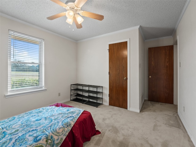 carpeted bedroom featuring ceiling fan, crown molding, and a textured ceiling