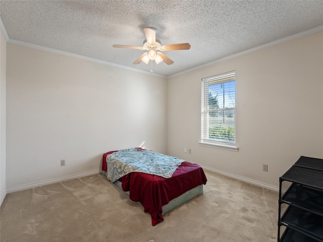 carpeted bedroom with ceiling fan, ornamental molding, and a textured ceiling