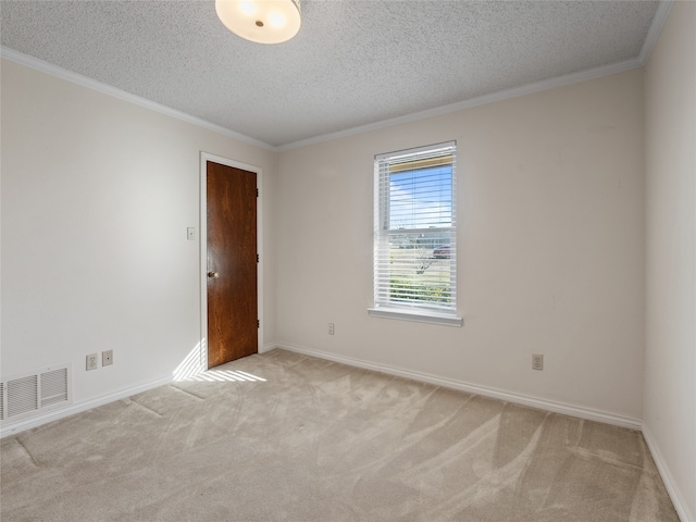 carpeted spare room with a textured ceiling and crown molding