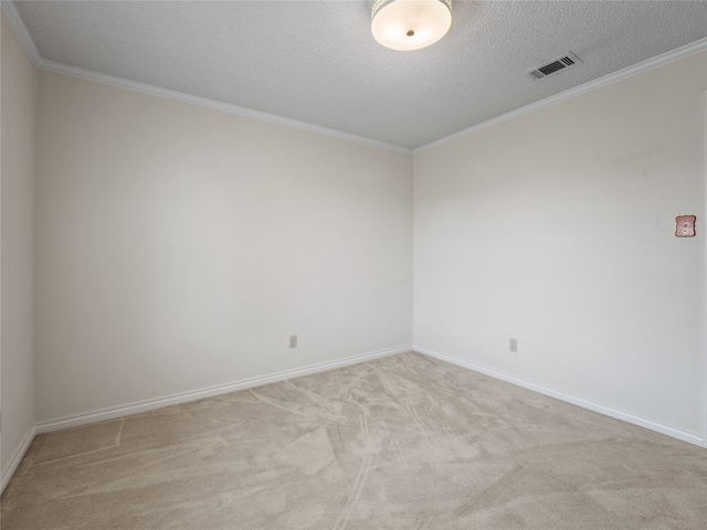 carpeted empty room with crown molding and a textured ceiling