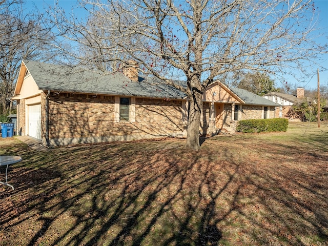 exterior space with a garage and a yard