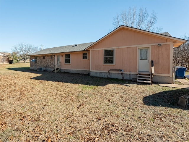 rear view of property with a yard