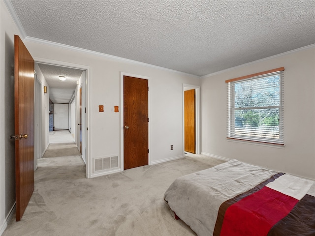 carpeted bedroom with a textured ceiling and crown molding