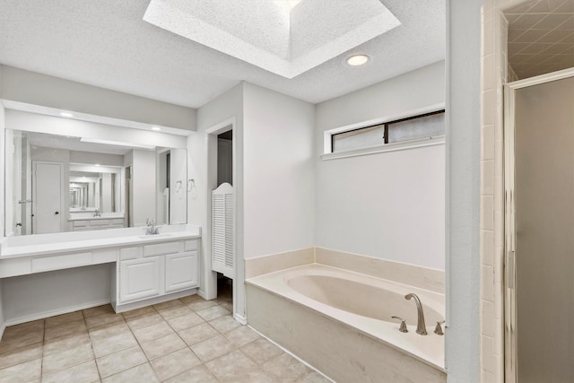 bathroom with vanity, tile patterned flooring, a textured ceiling, and plus walk in shower