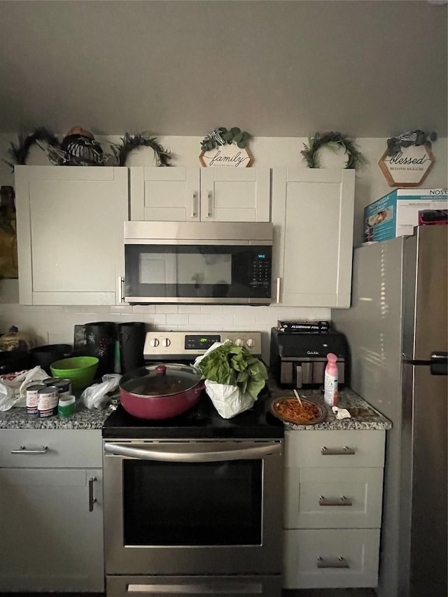 kitchen featuring white cabinets and appliances with stainless steel finishes