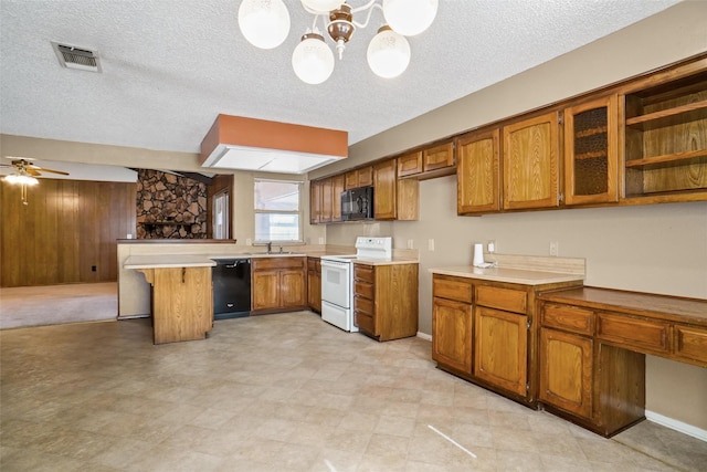 kitchen featuring wood walls, black appliances, ceiling fan with notable chandelier, hanging light fixtures, and a textured ceiling