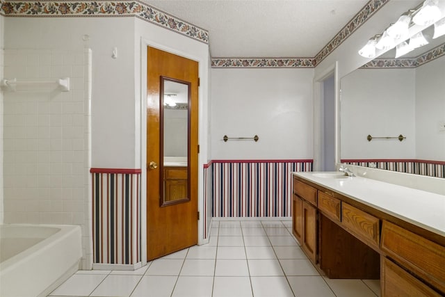 bathroom with tile patterned floors, vanity, and a textured ceiling