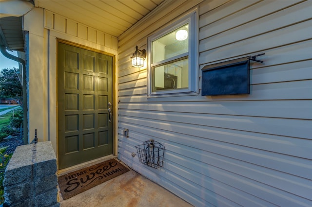 view of exterior entry with a porch