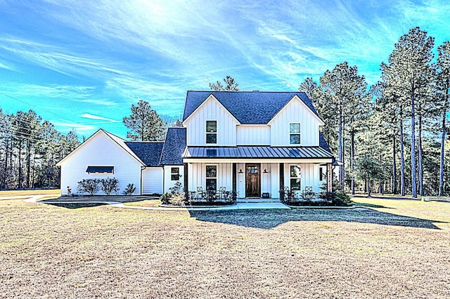 modern farmhouse featuring a front yard and a porch