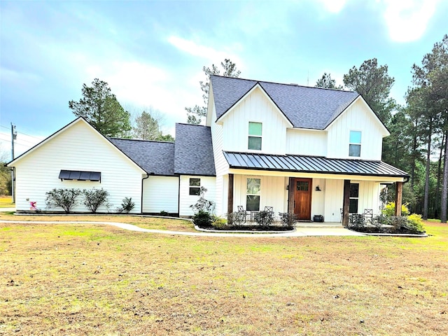 modern farmhouse style home with a porch and a front yard