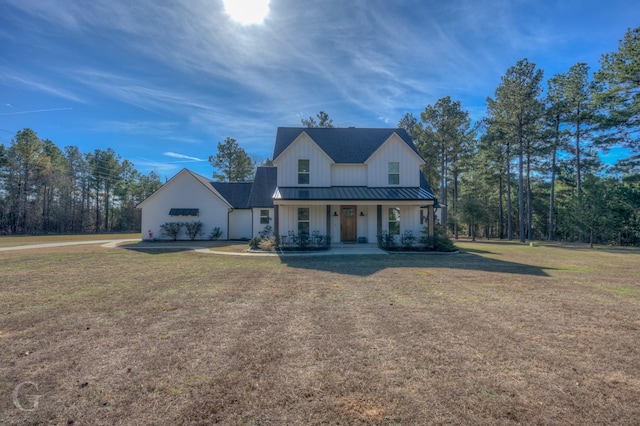 modern farmhouse style home featuring a porch and a front yard