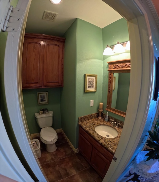 bathroom featuring tile patterned floors, vanity, and toilet