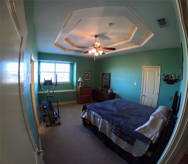 bedroom featuring a raised ceiling, ceiling fan, and crown molding