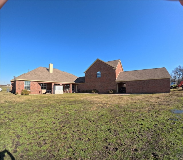 rear view of house with a yard