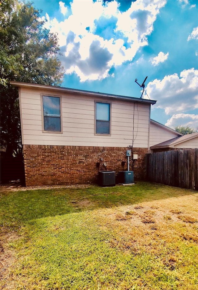 view of home's exterior featuring a lawn and central air condition unit