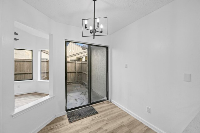 empty room with ceiling fan, light hardwood / wood-style floors, and vaulted ceiling