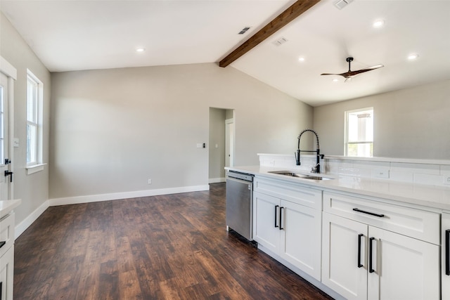 kitchen featuring a wealth of natural light, dishwasher, sink, ceiling fan, and white cabinets