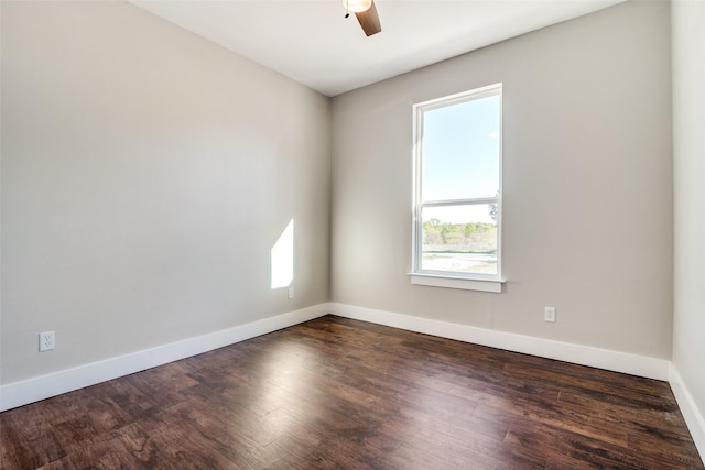 unfurnished room with ceiling fan and dark wood-type flooring