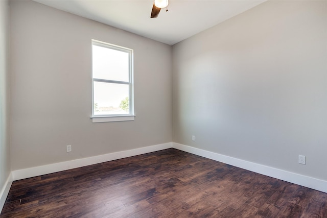 empty room with ceiling fan and dark hardwood / wood-style flooring