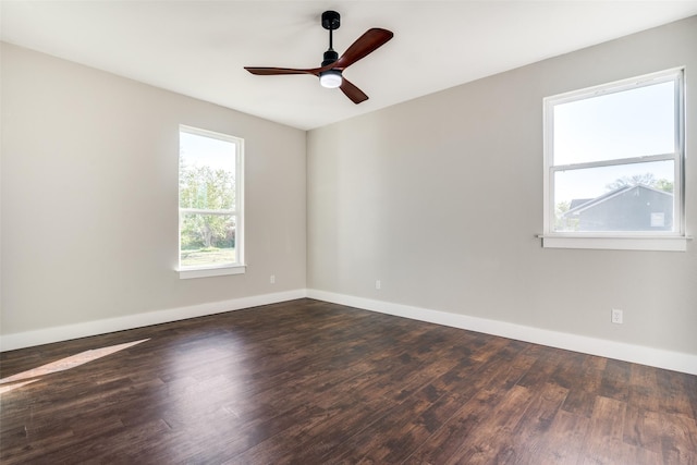 unfurnished room with dark hardwood / wood-style flooring and ceiling fan