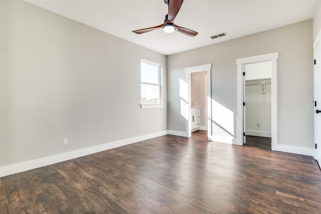 empty room featuring ceiling fan and dark wood-type flooring