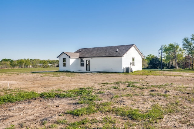 rear view of property featuring central AC unit