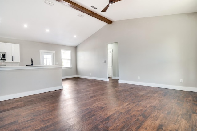 unfurnished living room featuring lofted ceiling with beams, dark hardwood / wood-style floors, and ceiling fan