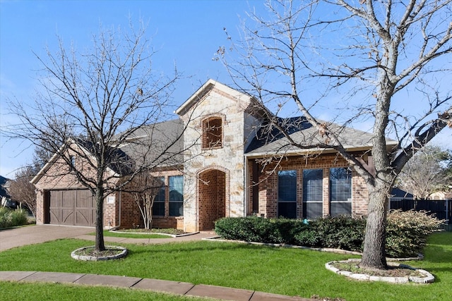 view of front of property featuring a garage and a front yard