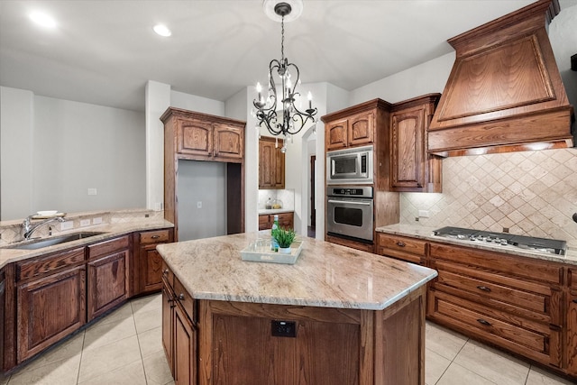 kitchen with a kitchen island, appliances with stainless steel finishes, custom range hood, and sink