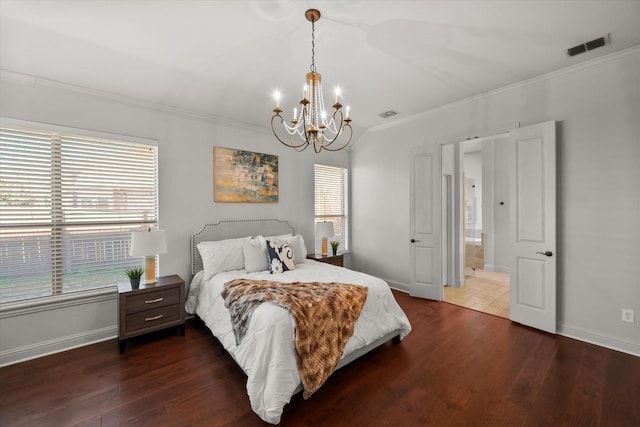 bedroom with a chandelier, ornamental molding, and dark hardwood / wood-style flooring