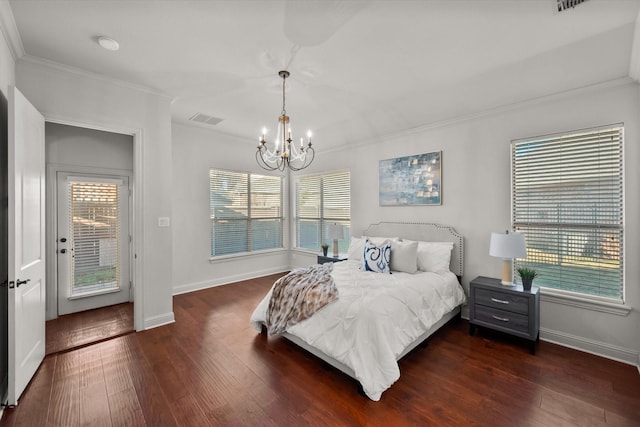 bedroom with ornamental molding, dark wood-type flooring, multiple windows, and access to exterior