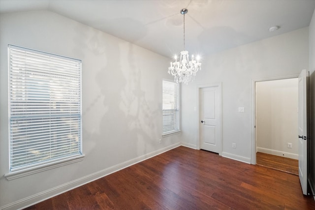 interior space featuring dark hardwood / wood-style flooring, an inviting chandelier, and vaulted ceiling