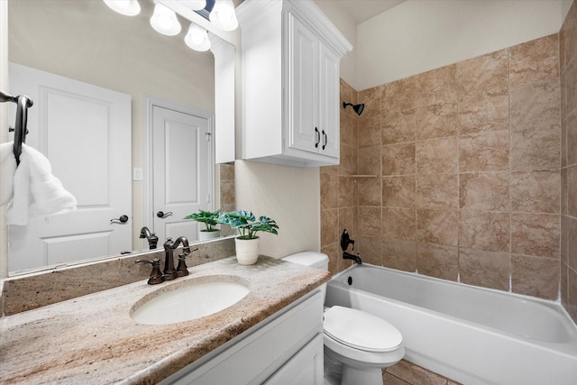 full bathroom with toilet, vanity, and tiled shower / bath combo