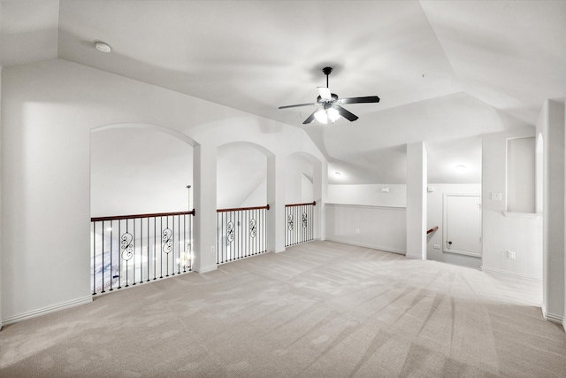 unfurnished room featuring ceiling fan, vaulted ceiling, and light carpet