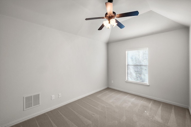 spare room featuring lofted ceiling, carpet floors, and ceiling fan