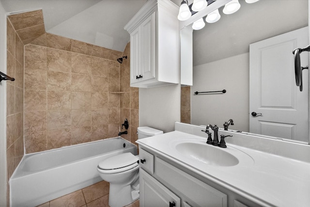 full bathroom featuring toilet, tiled shower / bath, tile patterned floors, and vanity