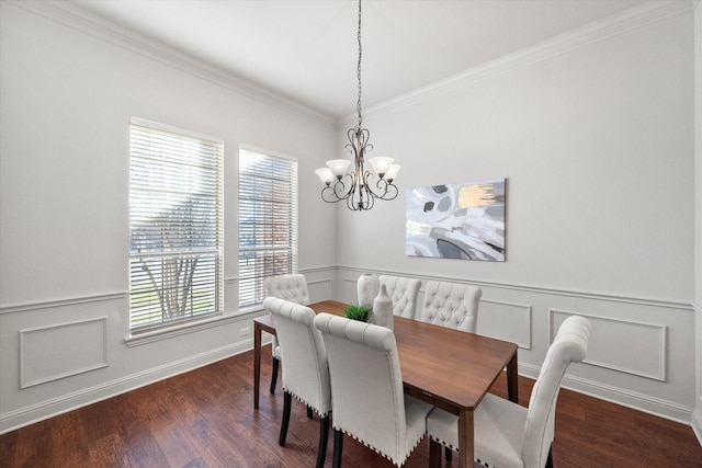 dining area featuring dark wood-type flooring, an inviting chandelier, and crown molding