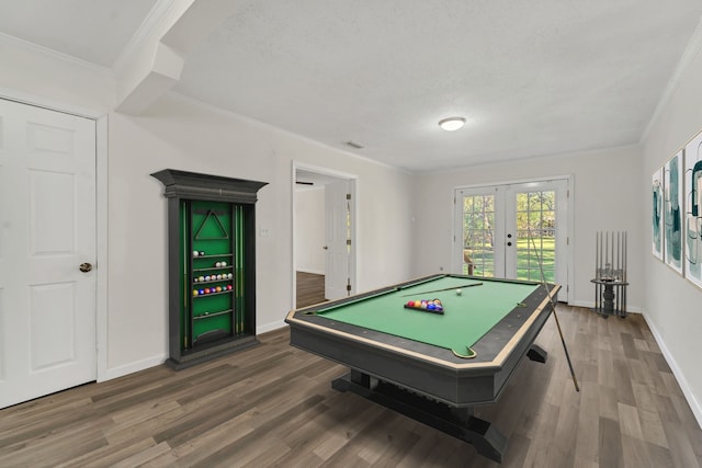 game room featuring dark hardwood / wood-style flooring, crown molding, billiards, and french doors